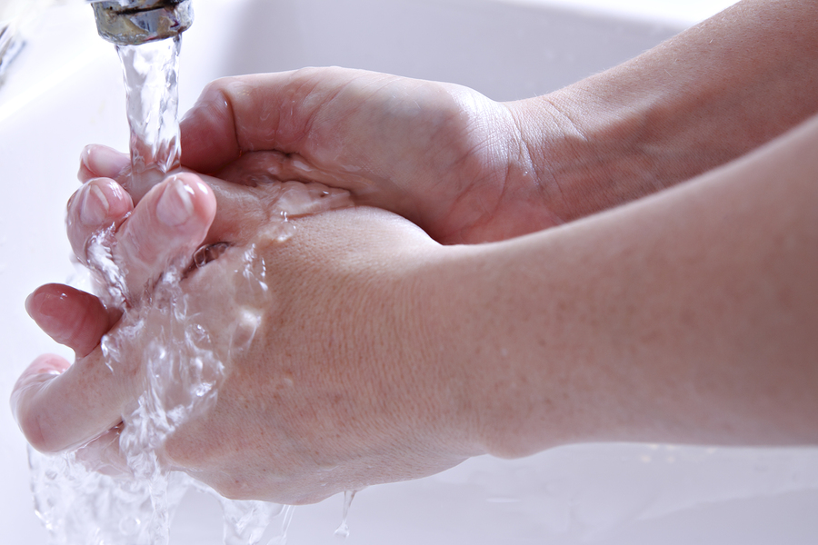 someone's washing their hands with water